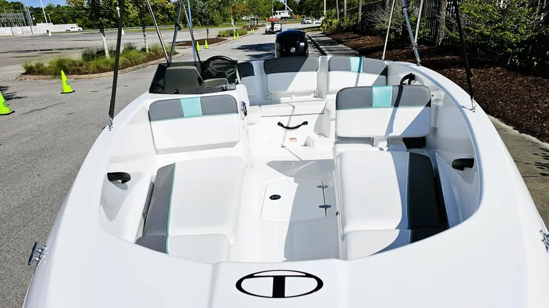 Slide: The Image of 2025 Tahoe T16 boat with spacious seating and modern design in a parking area. - 11
