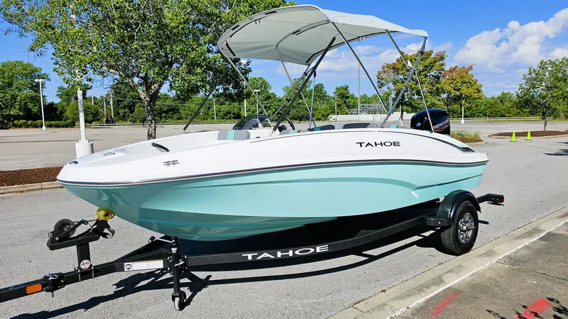 Slide: The Image of 2025 Tahoe T16 boat on trailer, parked outdoors under a clear blue sky. - 5