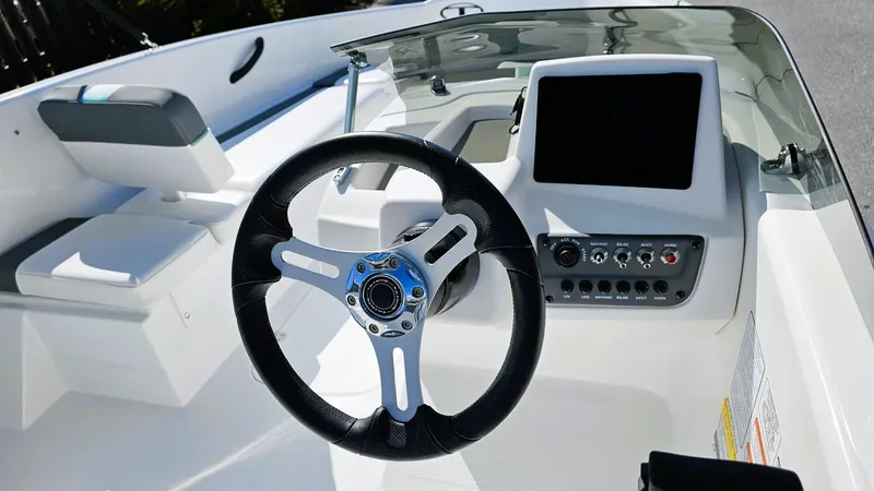 Slide: The Image of 2025 Tahoe T16 boat interior with steering wheel and control panel. - 8