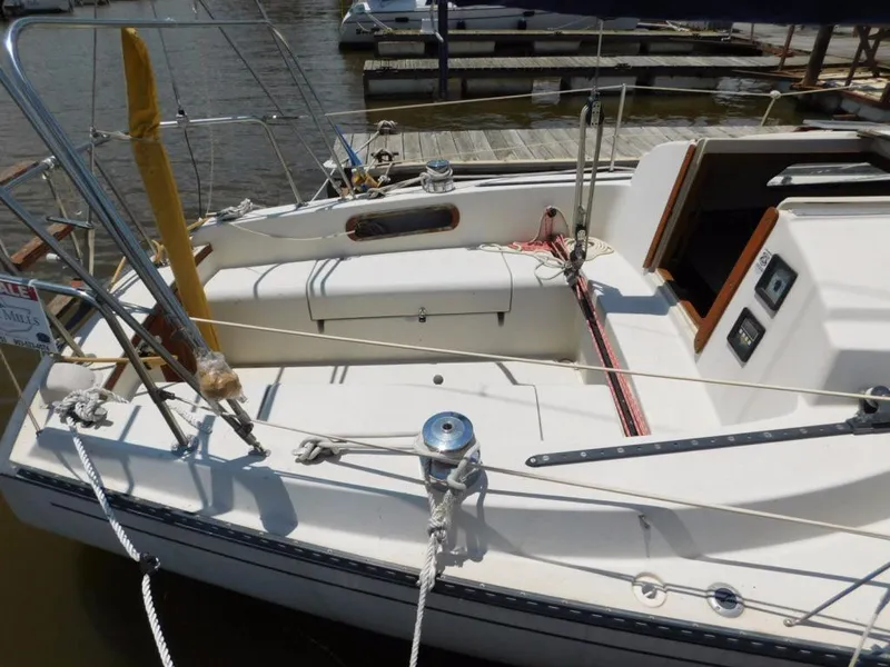 Slide: The Image of 1981 Pearson 32 sailboat cockpit with ropes and winch, docked at marina. - 10