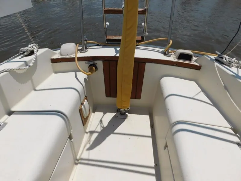 Slide: The Image of Cockpit of 1981 Pearson 32 sailboat with white seating and wooden accents. - 12