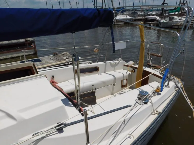 Slide: The Image of 1981 Pearson 32 sailboat docked at marina, featuring spacious cockpit and rigging. - 2