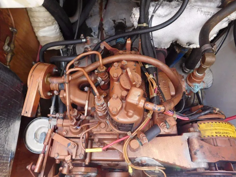 Slide: The Image of Engine of a 1981 Pearson 32 sailboat, showcasing intricate mechanical components and wiring. - 29