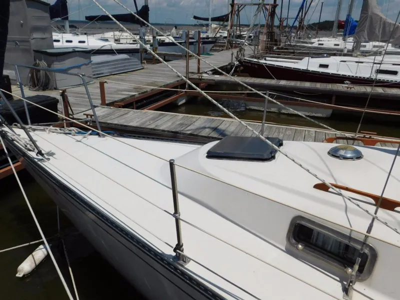 Slide: The Image of 1981 Pearson 32 sailboat docked at marina, showcasing deck and rigging. - 6