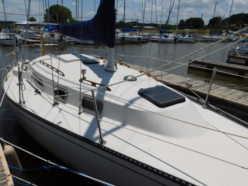 Slide: The Image of 1981 Pearson 32 sailboat docked at marina, featuring sleek white deck and blue sail. - 8