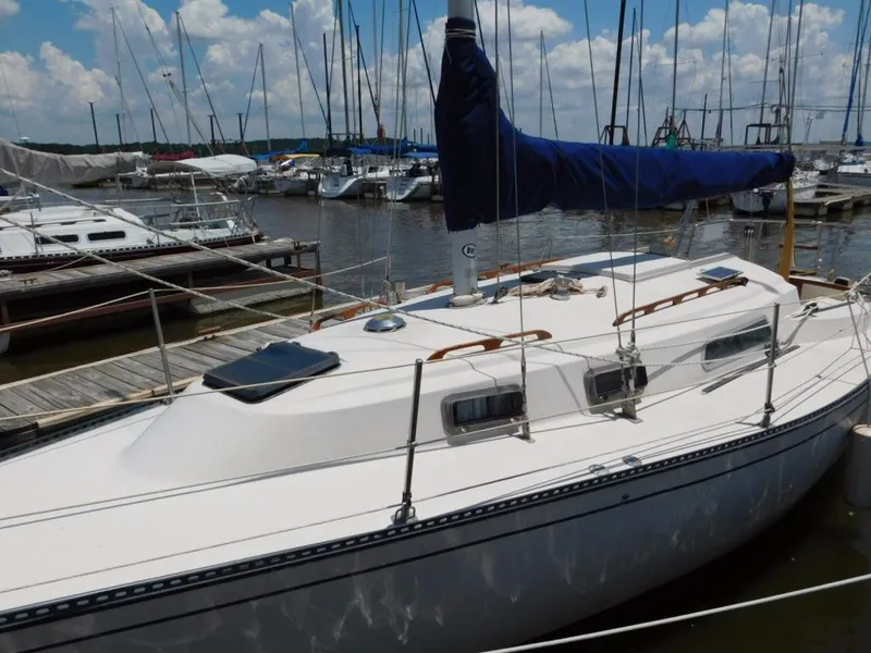 Slide: The Image of 1981 Pearson 32 sailboat docked at marina under blue sky. - 1