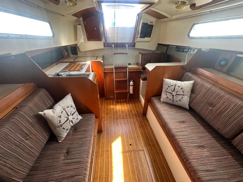 Slide: The Image of Interior of 1981 Pearson 32 sailboat with cozy seating and nautical decor. - 20