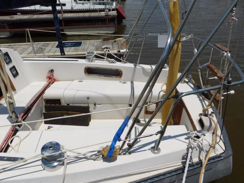 Slide: The Image of 1981 Pearson 32 sailboat cockpit with ropes and winches at a marina. - 4