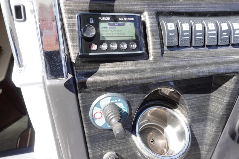 Slide: The Image of Control panel of 2018 Monterey 295 Sport Yacht with Fusion stereo and switches. - 10