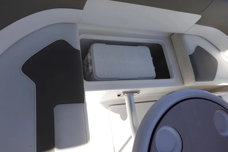 Slide: The Image of 2018 Monterey 295 Sport Yacht interior with storage compartment and cooler. - 15