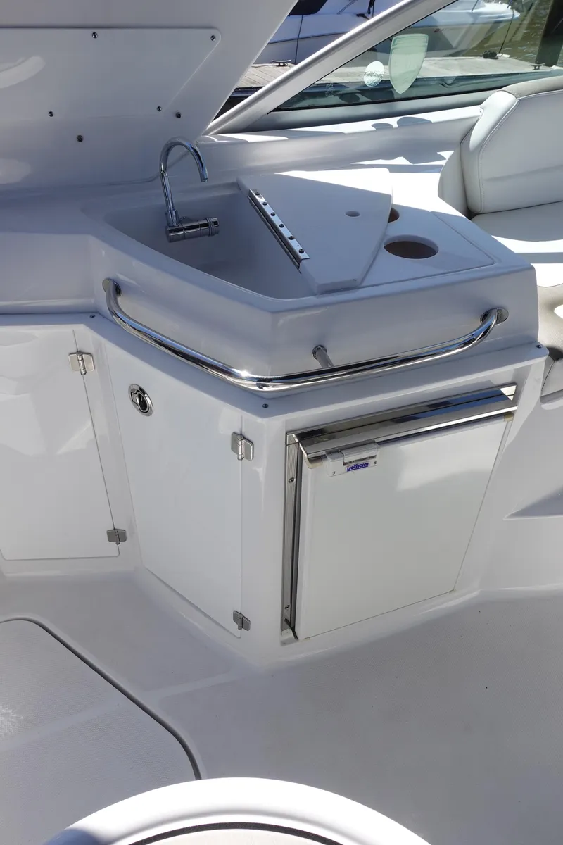 Slide: The Image of 2018 Monterey 295 Sport Yacht kitchenette with sink and mini fridge. - 17