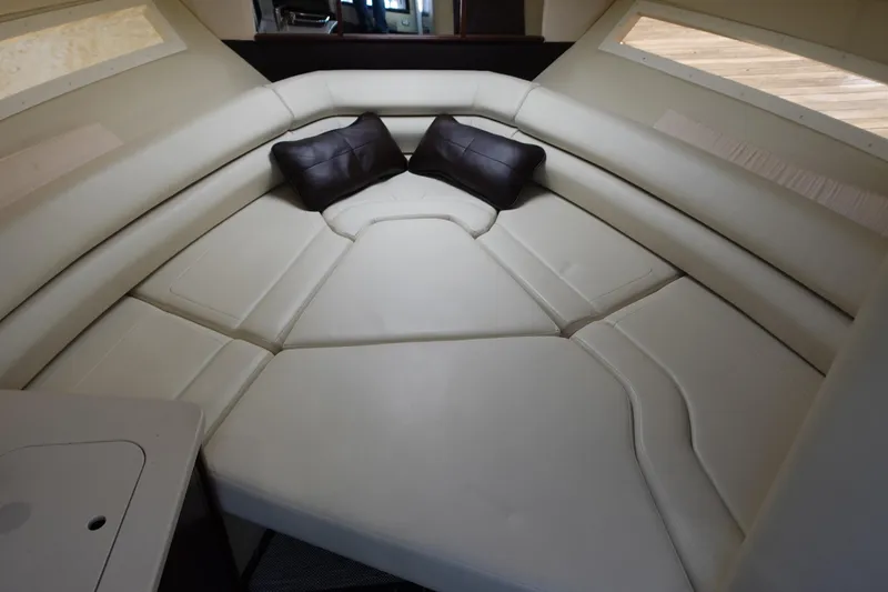 Slide: The Image of 2018 Monterey 295 Sport Yacht interior with cream seating and black cushions. - 20