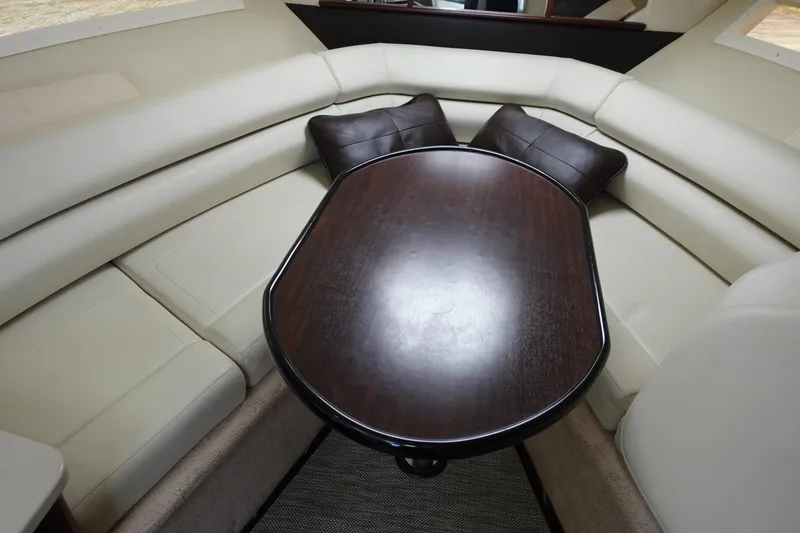 Slide: The Image of Interior of 2018 Monterey 295 Sport Yacht with elegant seating and wooden table. - 21