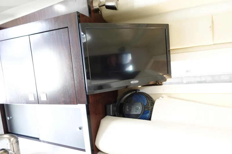 Slide: The Image of Interior of 2018 Monterey 295 Sport Yacht with TV and fan setup. - 23
