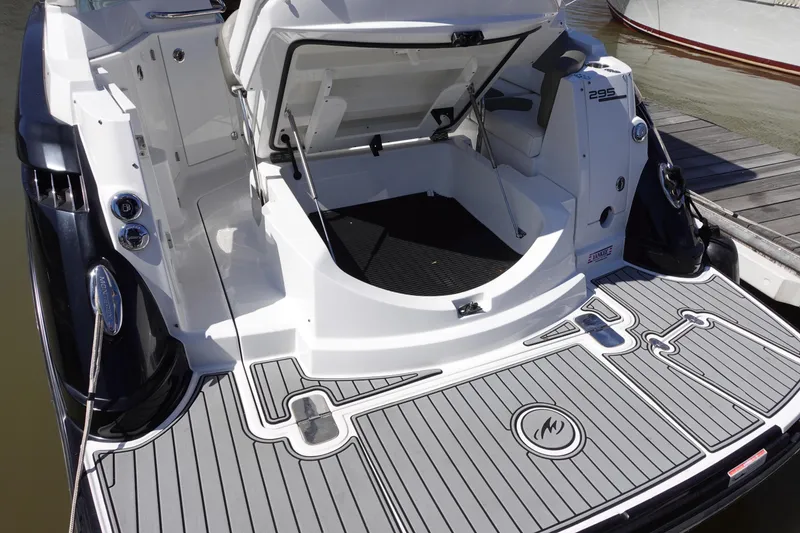 Slide: The Image of 2018 Monterey 295 Sport Yacht with open storage compartment and sleek deck design. - 6