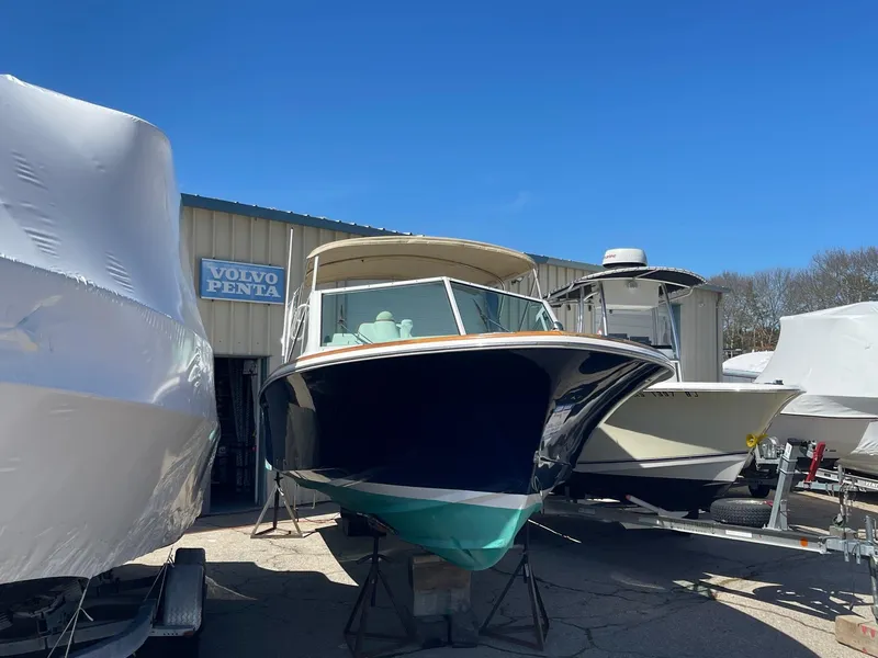 Slide: The Image of 2010 Hunt Yachts Harrier 25 boat in storage, surrounded by other vessels. - 1