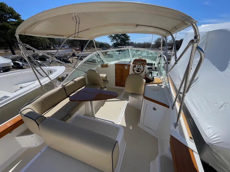 Slide: The Image of 2010 Hunt Yachts Harrier 25 interior with beige seating and wooden accents. - 11