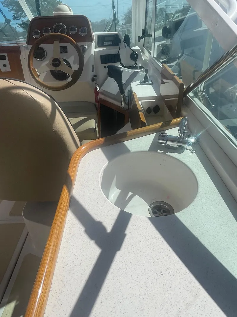 Slide: The Image of Interior of 2010 Hunt Yachts Harrier 25 with steering wheel and sink. - 12