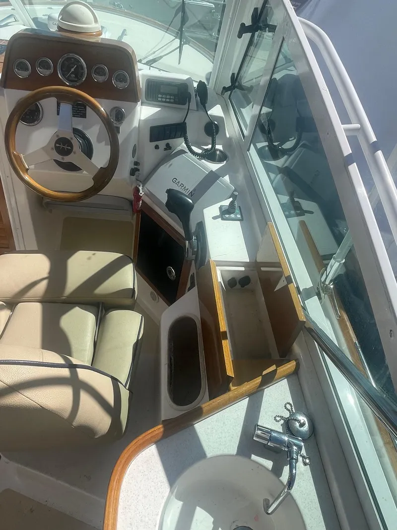 Slide: The Image of 2010 Hunt Yachts Harrier 25 cockpit with steering wheel and control panel. - 13