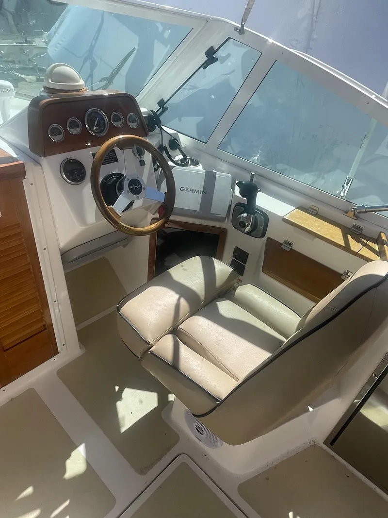 Slide: The Image of 2010 Hunt Yachts Harrier 25 cockpit with steering wheel and control panel. - 14