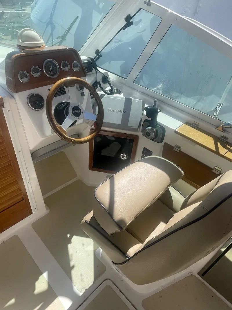 Slide: The Image of 2010 Hunt Yachts Harrier 25 cockpit with steering wheel and navigation instruments. - 15
