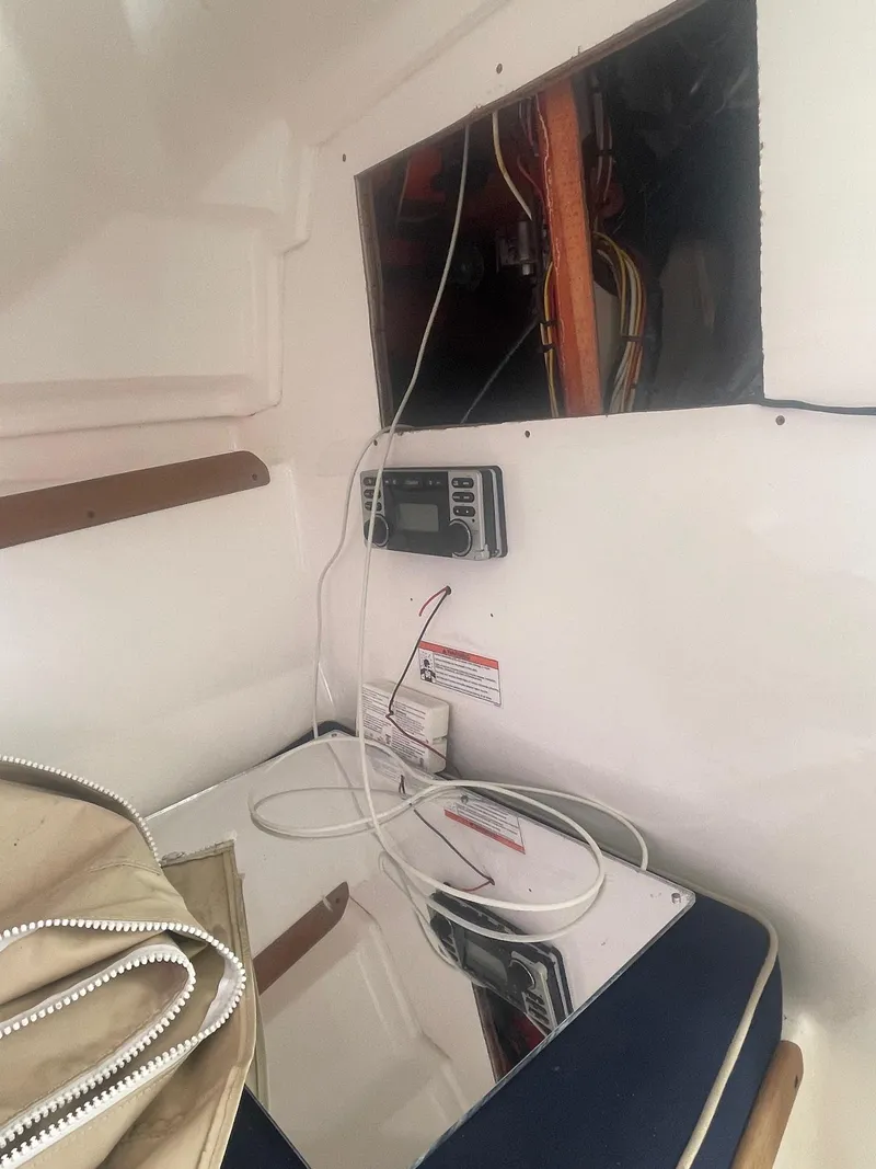 Slide: The Image of Interior view of a 2010 Hunt Yachts Harrier 25, showing wiring and control panel. - 18