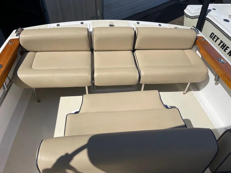Slide: The Image of 2010 Hunt Yachts Harrier 25 interior with beige seating and wooden accents. - 21