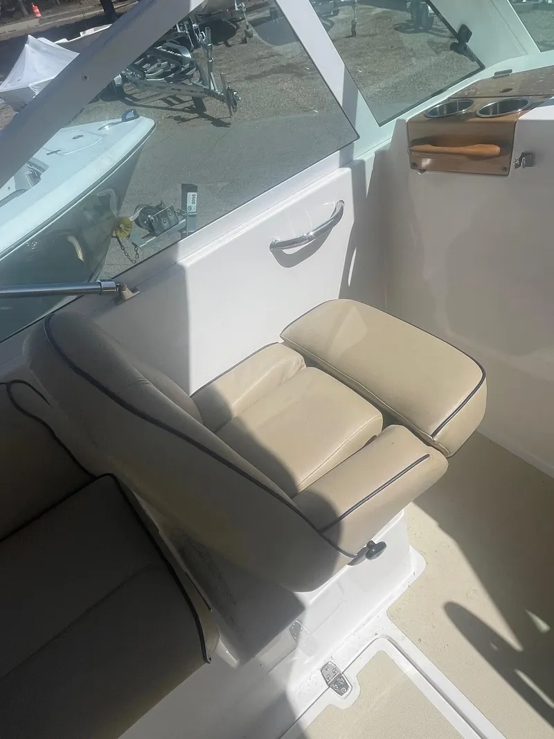 Slide: The Image of 2010 Hunt Yachts Harrier 25 interior with beige seating and sleek design. - 22