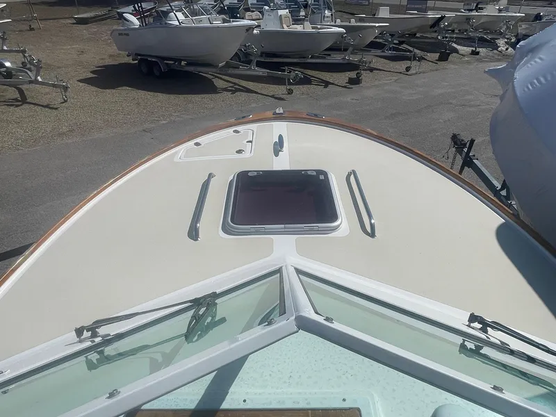 Slide: The Image of 2010 Hunt Yachts Harrier 25 bow view with hatch, parked among other boats. - 28