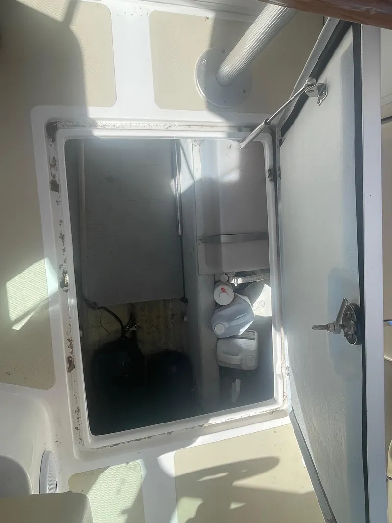 Slide: The Image of Open hatch on 2010 Hunt Yachts Harrier 25, revealing interior storage space. - 31