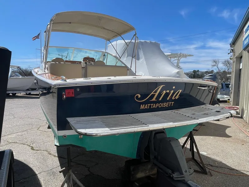 Slide: The Image of 2010 Hunt Yachts Harrier 25 boat named "Aria" in a marina setting. - 5