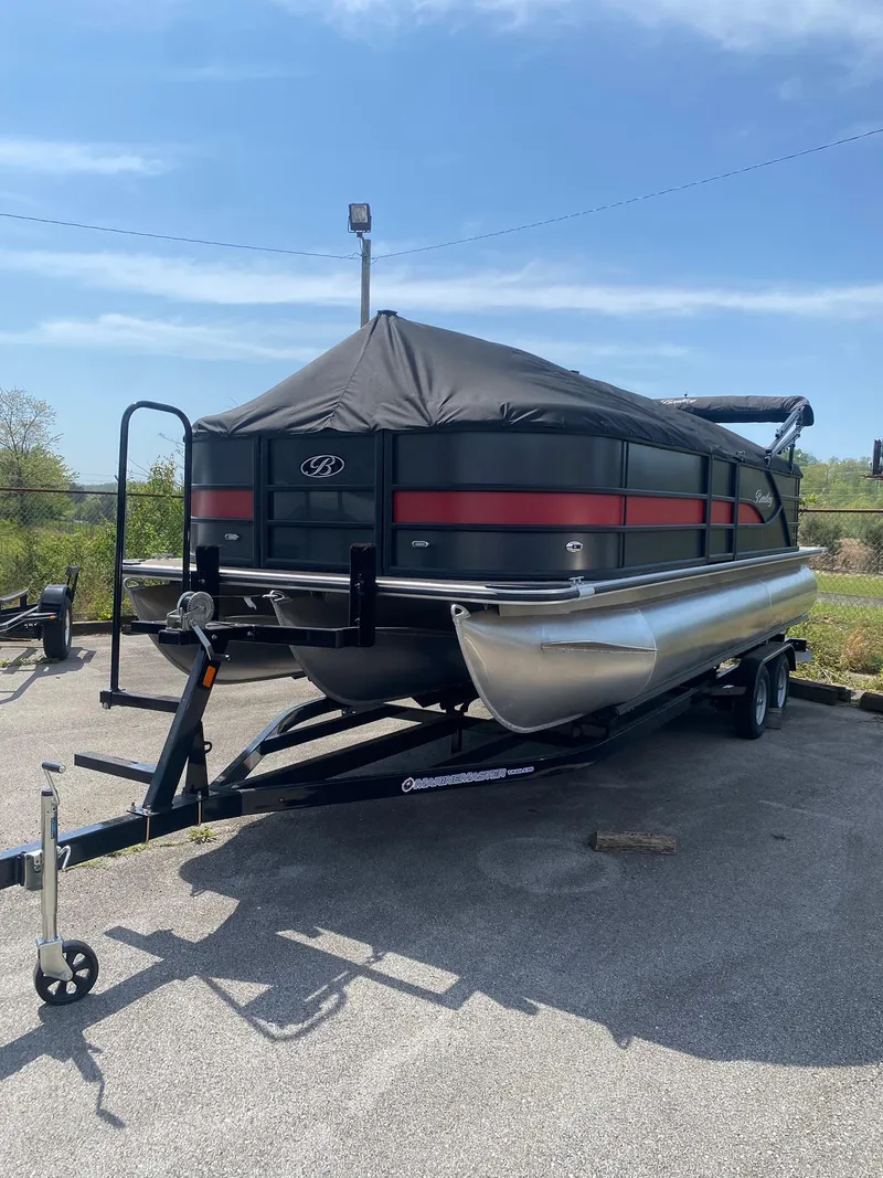 Slide: The Image of 2025 Bentley Pontoons Legacy 223 Navigator on trailer, covered and parked outdoors. - 1