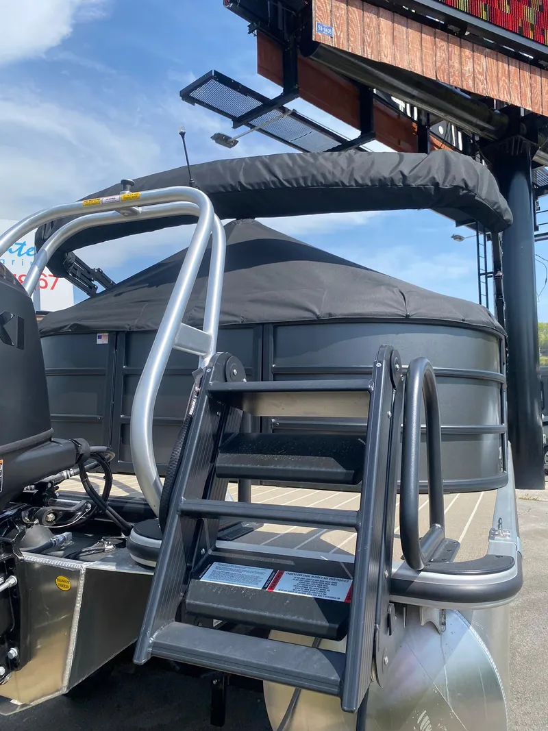 Slide: The Image of 2025 Bentley Pontoons Legacy 223 Navigator with canopy and ladder, displayed outdoors. - 10