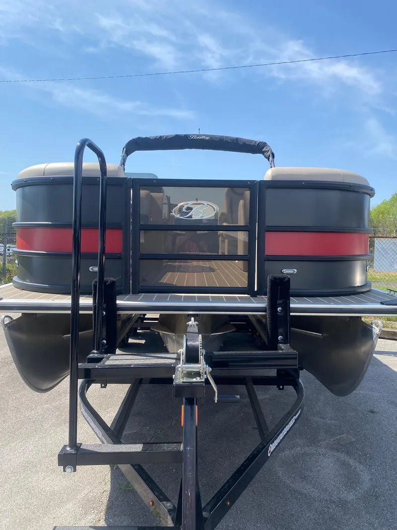 Slide: The Image of 2025 Bentley Pontoons Legacy 223 Navigator on trailer, rear view, sunny day. - 13