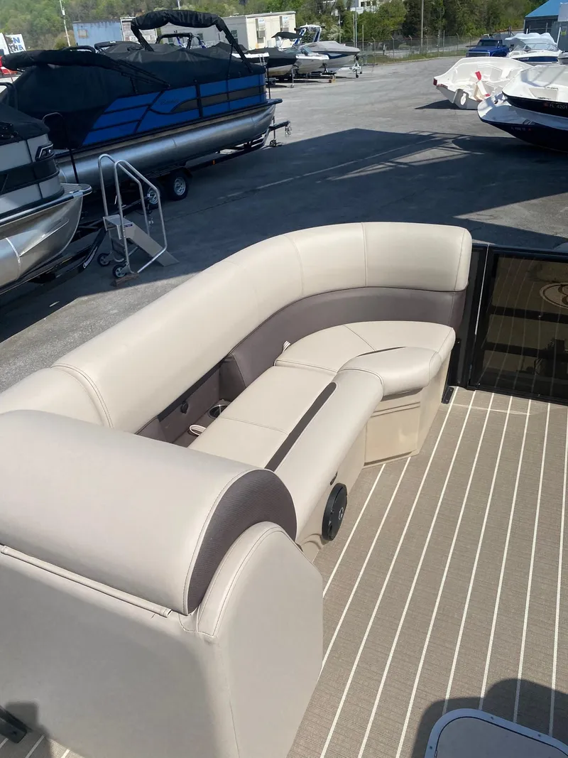 Slide: The Image of 2025 Bentley Pontoons Legacy 223 Navigator with beige seating on a docked pontoon boat. - 23