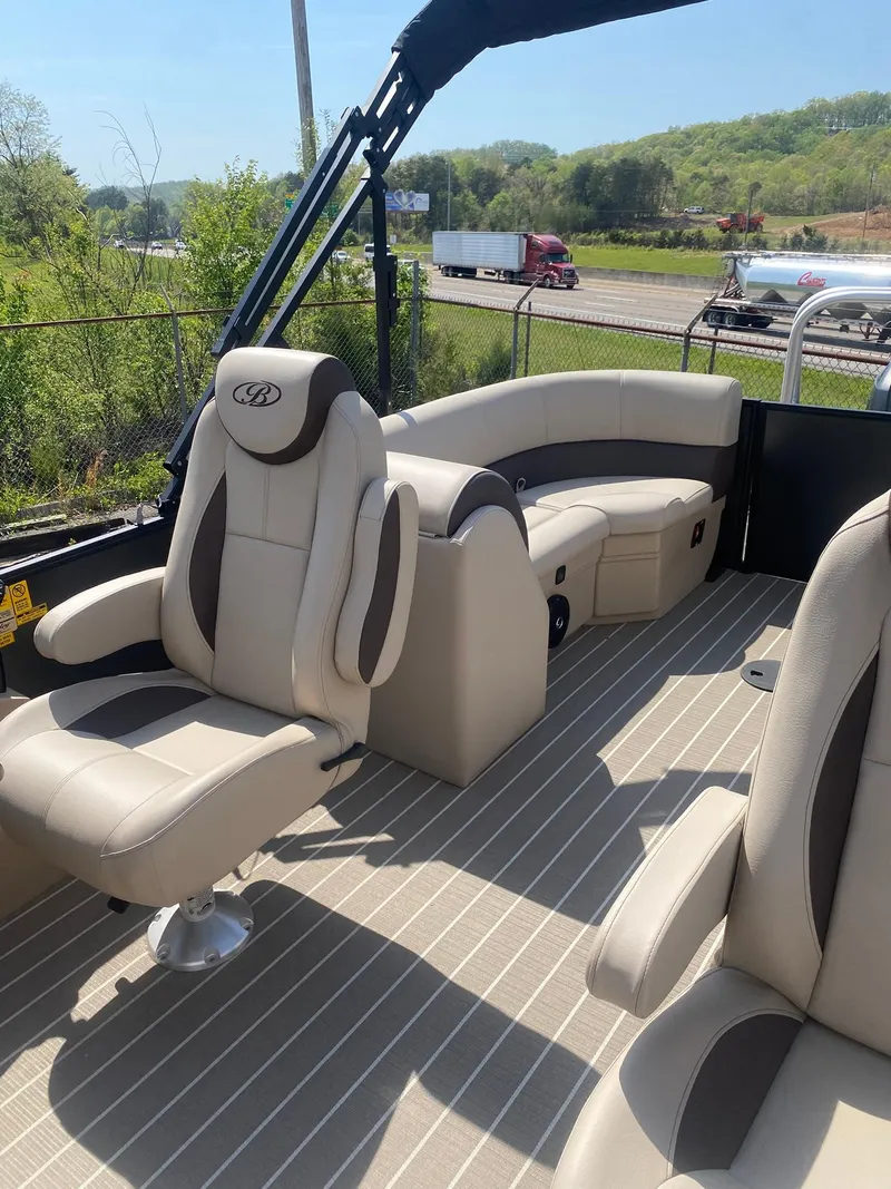 Slide: The Image of 2025 Bentley Pontoons Legacy 223 Navigator interior with beige seating and striped flooring. - 27