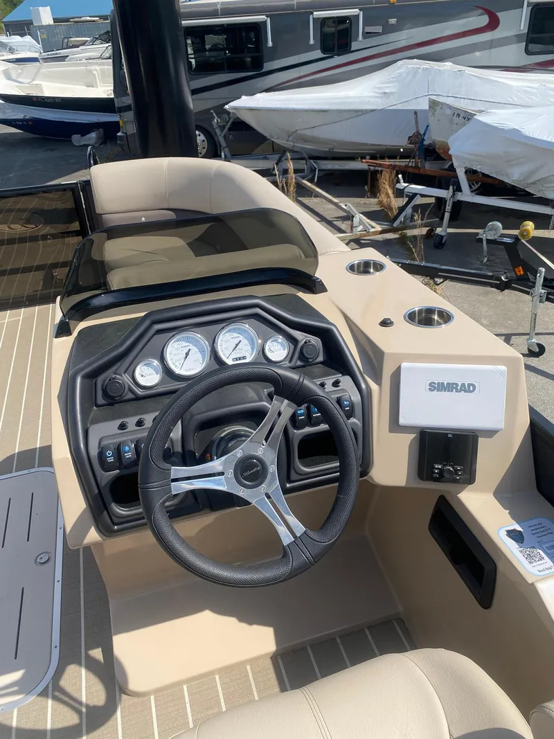 Slide: The Image of 2025 Bentley Pontoons Legacy 223 Navigator dashboard with steering wheel and gauges. - 29