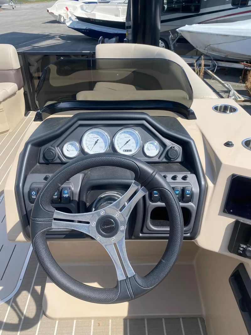 Slide: The Image of 2025 Bentley Pontoons Legacy 223 Navigator dashboard with steering wheel and gauges. - 31