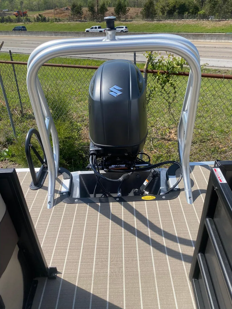 Slide: The Image of 2025 Bentley Pontoons Legacy 223 Navigator with Suzuki outboard motor, viewed from deck. - 32