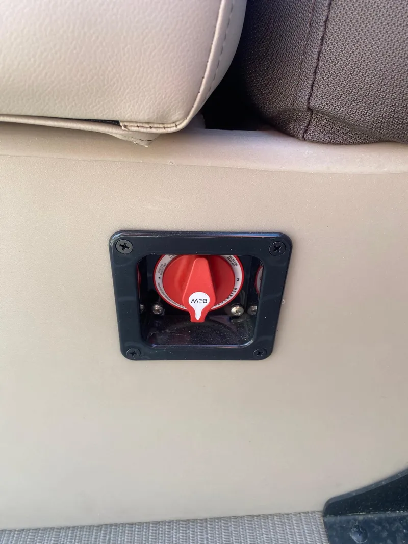 Slide: The Image of 2025 Bentley Pontoons Legacy 223 Navigator battery switch on beige interior panel. - 33