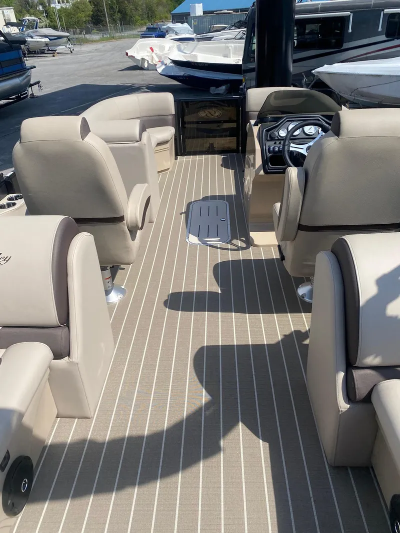 Slide: The Image of 2025 Bentley Pontoons Legacy 223 Navigator interior with beige seating and modern dashboard. - 34