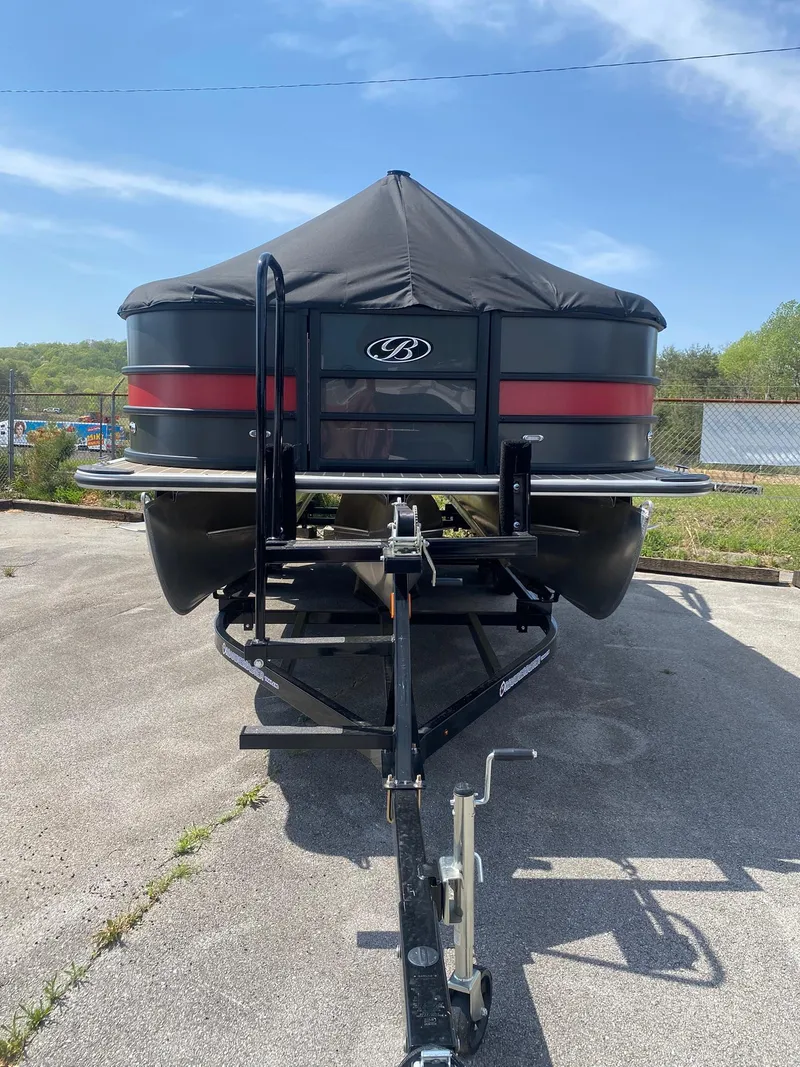 Slide: The Image of 2025 Bentley Pontoons Legacy 223 Navigator on trailer, front view, outdoors. - 5