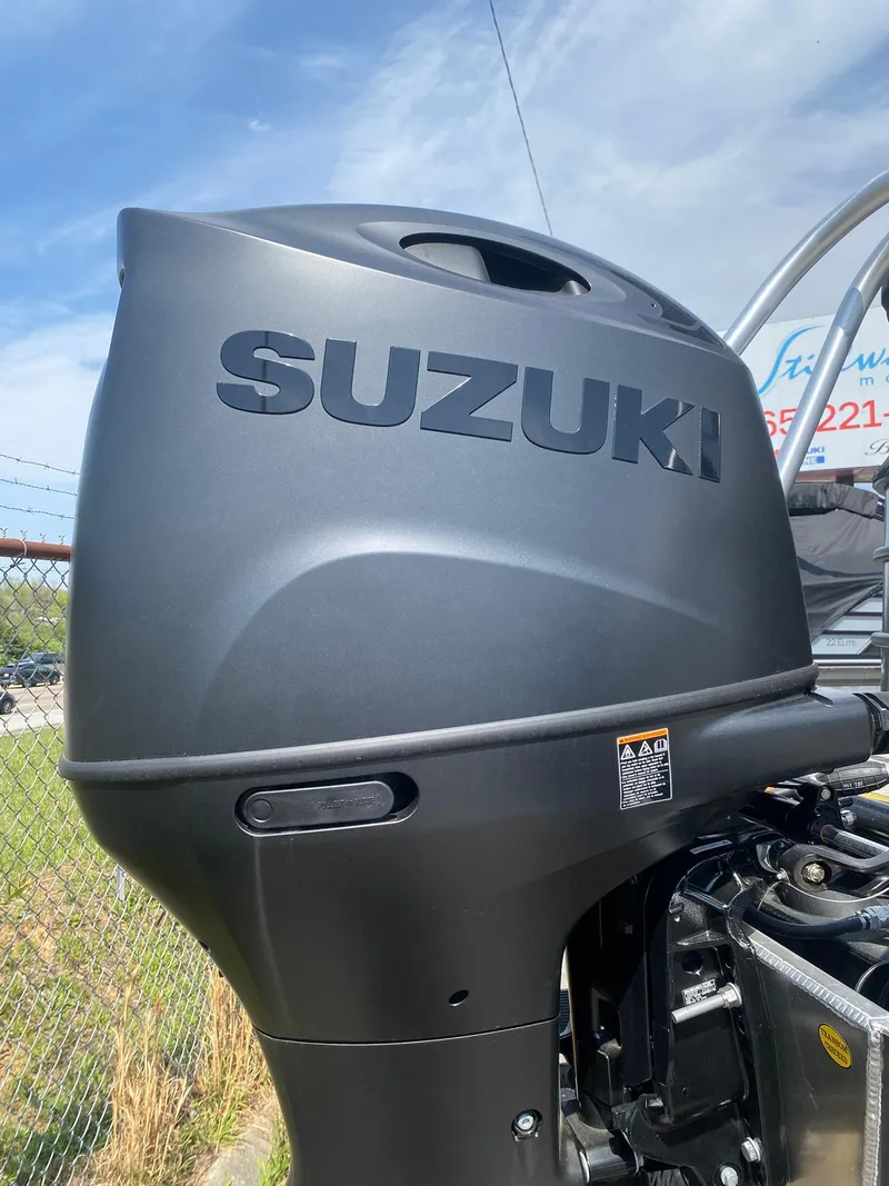 Slide: The Image of Suzuki outboard motor on 2025 Bentley Pontoons Legacy 223 Navigator, outdoor setting. - 8