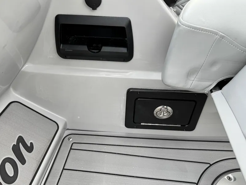 Slide: The Image of Interior of 2025 JC SportToon 24 TT DSL boat, featuring seating and storage compartments. - 10