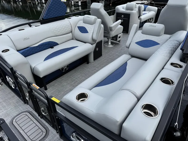 Slide: The Image of Luxurious 2025 JC SportToon 24 TT DSL pontoon boat interior with plush seating and cup holders. - 15