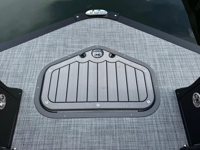 Slide: The Image of 2025 JC SportToon 24 TT DSL boat deck with textured surface and hatch. - 5