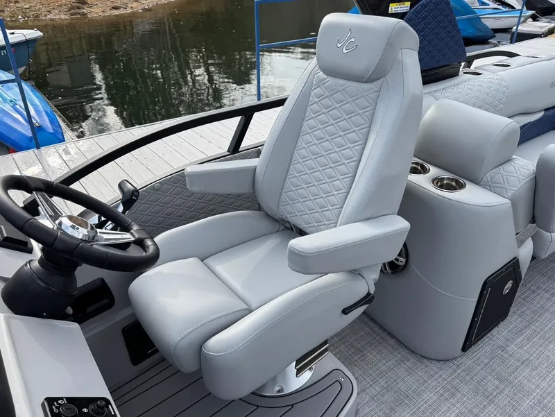 Slide: The Image of Luxurious 2025 JC SportToon 24 TT DSL boat interior with plush captain's chair and sleek design. - 8