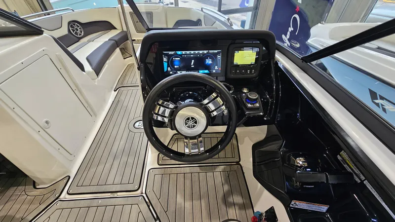 Slide: The Image of 2021 Yamaha Boats 212SD cockpit with modern steering and digital controls. - 13