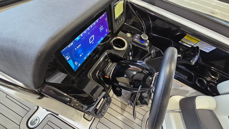 Slide: The Image of 2021 Yamaha Boats 212SD dashboard with touchscreen display and steering wheel. - 15