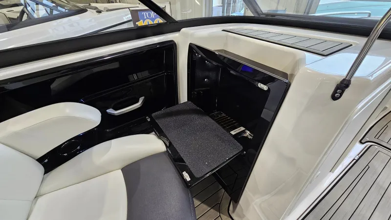 Slide: The Image of Interior of 2021 Yamaha Boats 212SD, featuring seating and storage compartment. - 17